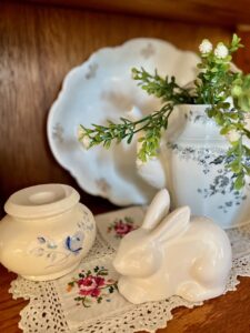 vintage and thrifted decor finds in a blue and white themed curio cabinet 