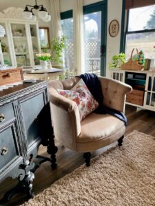 Vintage Pier 1 barrel chair styled in a secondhand living room with thrifted decor and accessories