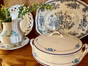 antique curved curio cabinet with spring decor in a cozy vintage bedroom
