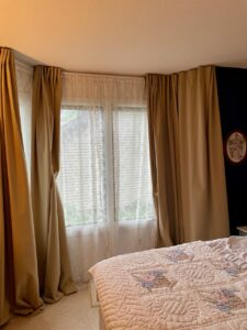 Low-sensory bedroom styled with thrifted antiques and muted tones