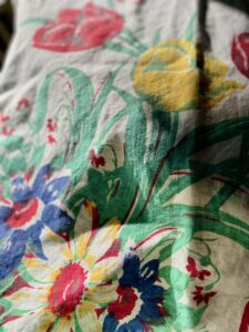 close up of vintage linen tablecloth with florals