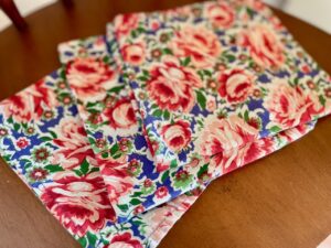 thrifted cloth napkins fanned out in a flat lay showing various vintage patterns