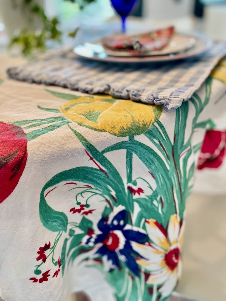thrifted linen haul from Goodwill vintage floral tablecloth styled with summer linens