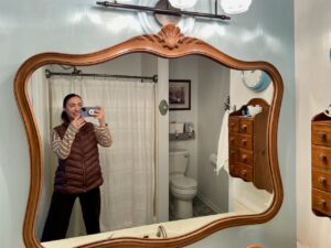  Thrifted vintage mirror hanging in a small bathroom with character-rich decor