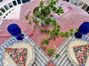 a summer table setting with thrifted linens and dishes