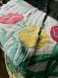 close-up detail of a vintage floral tablecloth pattern found at Goodwill