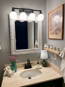 Wide shot of a vintage bathroom styled entirely with thrifted finds