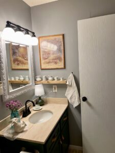 Warm lifestyle shot of a vintage bathroom with soft light and layered textures