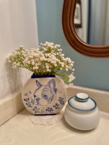 Close-up of a vintage lidded dish used decoratively in a bathroom setting