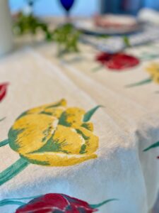 close-up shot of a thrifted vintage table cloth with red and yellow tulips