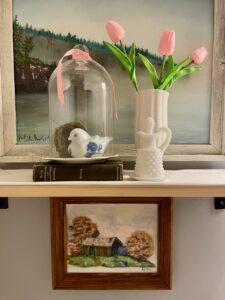 vintage thrifted art displayed in a bathroom