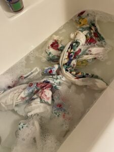 washing and cleaning vintage linen tablecloths in a tub for delicate cleaning