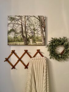 Wood peg rack with towels hanging in a vintage styled bathroom
