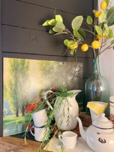 thrifted art styled on a mantel for summer