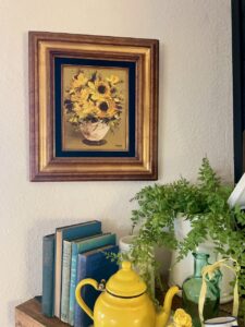 a thrifted vintage oil painting styled alongside a summer mantel