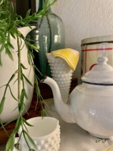 vintage milk glass styled on a mantel for summer