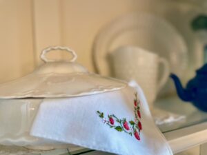 vintage strawberry hanky in a cottage-style hutch summer display