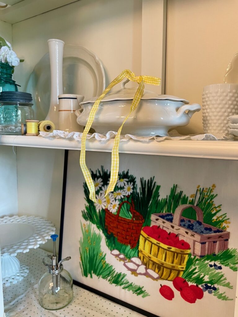 Thrifted summer hutch decor with old soul — blue ball jars, milk glass, and cottage garden flowers