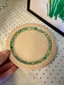 vintage restaurantware plate styled in a hutch for late-summer decor