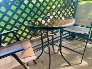 high top table and chair set for seating on a small patio