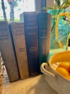 a row of thrifted antique books styled for vintage summer decor