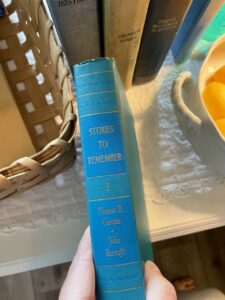 thrifted blue book with decorative spine to use in vintage decorating
