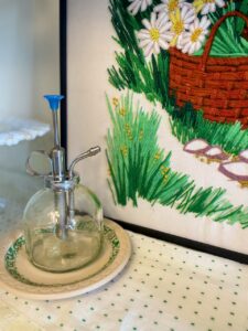 thrifted summer vignette inside a hutch