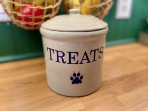 a red wing pottery dog treat jar on a counter