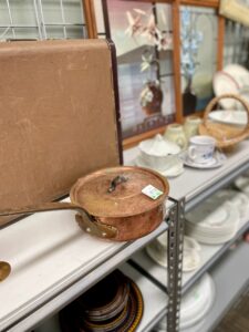 Thrifting for mental health and creativity, browsing shelves of secondhand finds