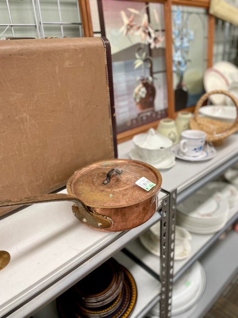 Thrifting for mental health and creativity, browsing shelves of secondhand finds
