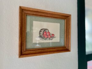 thrifted vintage artwork styled in a modern home