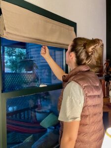 installing custom linen shades for a living room window