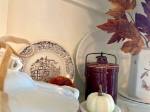 ironstone and other vintage decor used in a fall hutch display