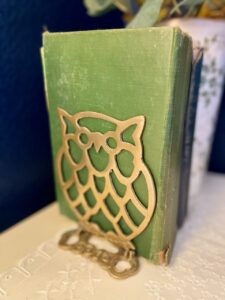 thrifted brass owl bookend used on a dresser for fall decor