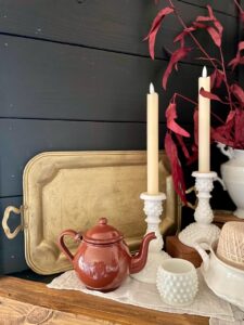 thrifted vintage brass tray styled on a mantel for fall decor