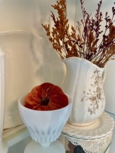 faux fall foliage placed inside a hutch