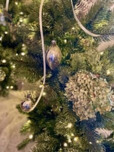 antique Shiny Brite ornaments hung on a King of Christmas tree