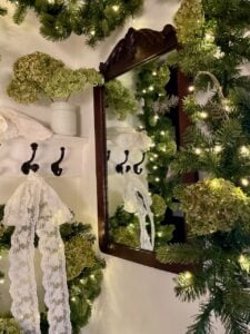 an antique mirror in a Christmas entryway display