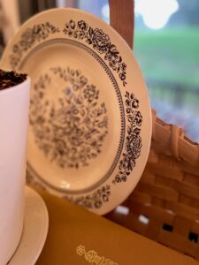 vintage plate in a basket vignette 